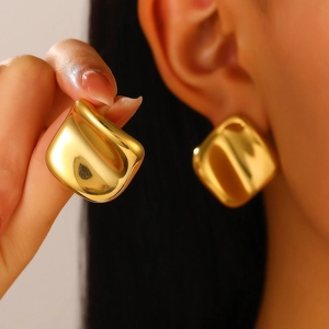 Macro shot of chunky vintage square stud earrings in polished 18K gold plated stainless steel