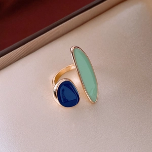 Macro shot of gold adjustable ring with leopard pattern green and blue enamel drips