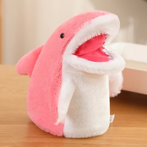 Cute pink and white plush shark hand puppet with soft fur on a light wooden table
