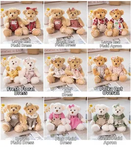 Detail of teddy bear plush toys in various vintage outfits with red checks and floral patterns