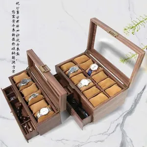 Detail view of walnut grain watch box with clear window and velvet pillows
