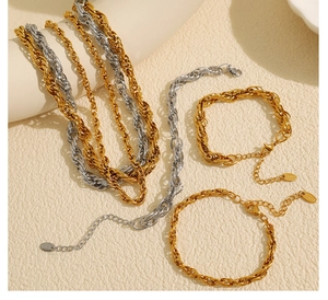 Detail view of gold and silver twisted rope chains with adjustable lobster clasp
