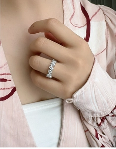 Close-up of S925 sterling silver eternity band with sparkling diamonds on a hand