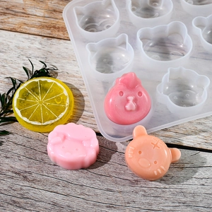 Detail of 12-cavity silicone mold showing cartoon animal shapes and finished resin art