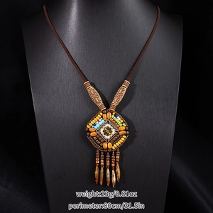Macro detail of Bohemian beaded necklace featuring colorful beads and long fringe tassels