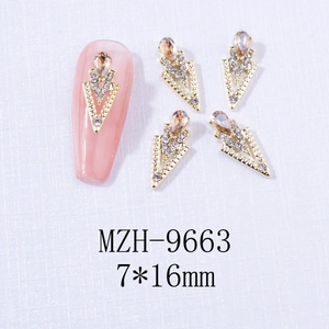 Detailed view of alloy nail charms with amber teardrop rhinestones in 7x16mm size
