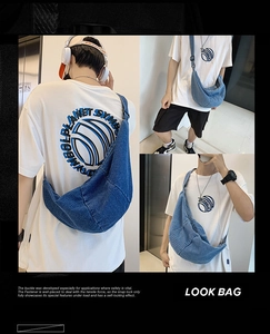 Three-way view of a large blue denim crescent crossbody bag showing front and side fit