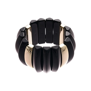 Modern acrylic bracelet with glossy black and polished gold metal blocks on white background