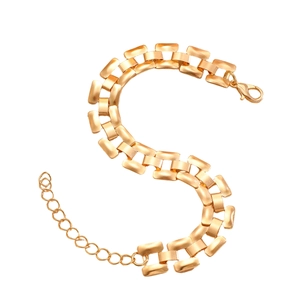 Detail of gold metal watchband link bracelet with matte texture and adjustable chain