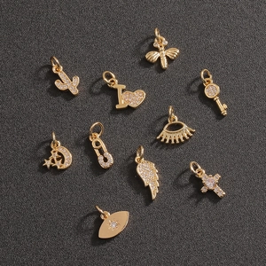 Set of 10 golden metal DIY charms featuring cactus, heart, bee, and cross designs