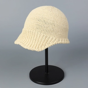 Detail of the thick crochet weave texture on this stylish beige knit aviator cap