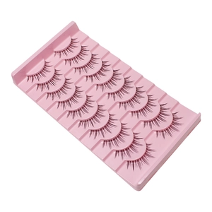 Close-up of five pairs of natural black eyelashes arranged on a pink plastic tray