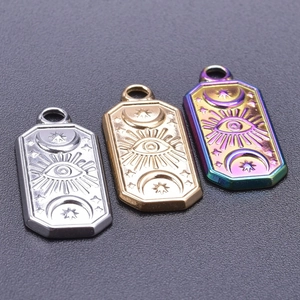 Detail of stainless steel evil eye charms in silver, gold, and rainbow finish