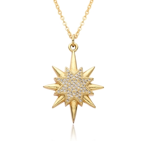 Macro view of gold-plated starburst necklace pendant with micro-paved cubic zirconia crystals