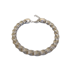 Exaggerated silver metal chunky torque choker necklace with twisted ribbed geometric design