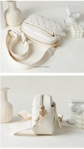 Close-up of beige quilted crossbody bag with golden zippers and wide woven shoulder strap
