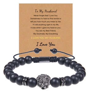 Detail of matte black stone bead bracelet with silver lion head and heartfelt gift card