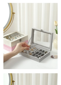 Detail of velvet jewelry box featuring transparent glass lid and metal latch closure