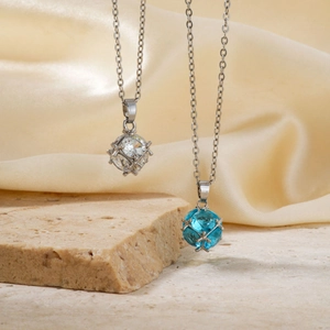 Elegant cube crystal pendant necklace set in blue and clear on silk with stone texture