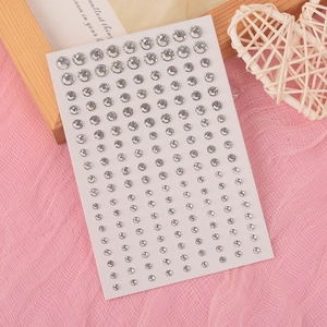 Close-up of Aurora butterfly tear rhinestone face stickers with silver gradient crystal gems
