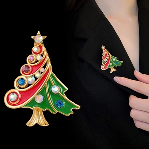 Christmas tree brooch with red green enamel and rhinestones shown on model and macro
