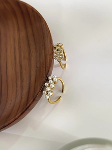 Close-up of adjustable 18K gold plated rings with white pearls and sparkling rhinestones