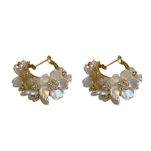 Elegant gold flower C-shaped earrings with white acrylic petals and crystals