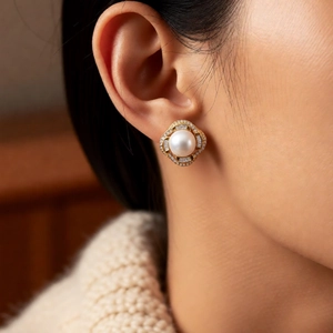 Close-up of luxury pearl earrings with zircon inlay and vintage gold court style details