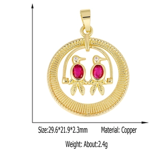 Detailed view of a gold-plated bird pendant with red gemstone settings and size specs