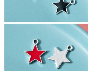 Close-up of colorful star charms in black, red, and silver with enamel detail