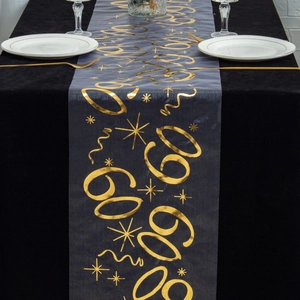 Close-up of black mesh table runner with gold foil 60th anniversary star pattern