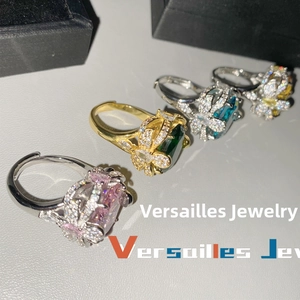 Macro detail of luxury rings with oversized gems and butterfly-shaped diamond pavé