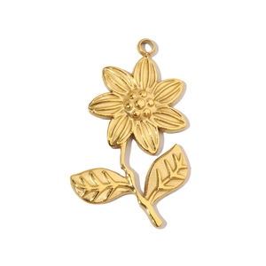 Macro shot of gold sunflower pendant in titanium steel with detailed petals and leaf