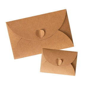 Vintage kraft paper envelopes with heart buckle closure in various sizes on white background