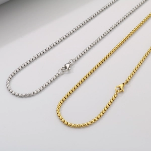 Detailed close-up of gold and silver stainless steel box chains with lobster clasps
