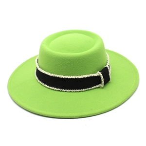 Close-up of wool felt hat with black ribbon and delicate pearl trim detail