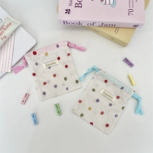 Detailed view of cotton linen drawstring pouches with colorful polka dots and Sozakka tag