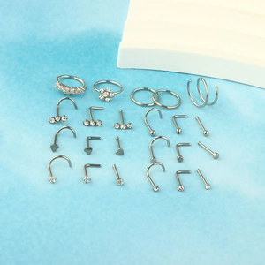Detail of 23-piece silver stainless steel nose stud set with heart and flower designs
