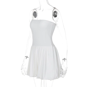 Detail view of white strapless mini dress with ruffled hem on transparent mannequin
