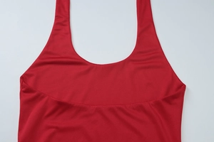 Close-up of vibrant red halter neck straps and knit texture on this sexy summer top