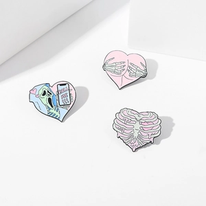 Pastel enamel heart pins set with skull, scream mask and ribcage skeleton designs