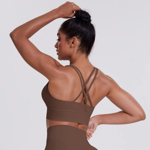 Detail of brown sports bra showing thin criss-cross back straps and wide elastic underband
