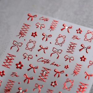 Metallic red velvet bow nail stickers with corset and star relief designs for nail art