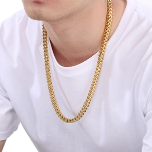Close-up of a gold-plated stainless steel Franco wheat chain necklace worn by a male model