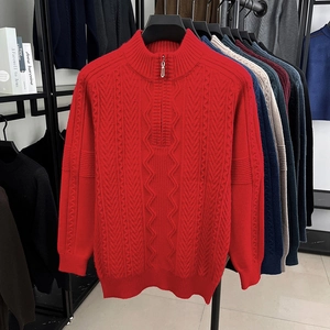 Detailed view of red zip-up stand collar men's sweater with heavy cable knit patterns