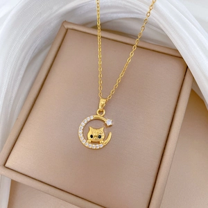 Detail of moon cat pendant with zircon stones in a gold finish jewelry gift box