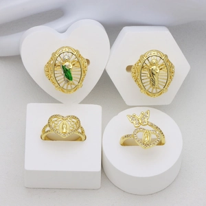 Golden open rings set featuring cutout heart designs, butterfly motifs, and green enamel