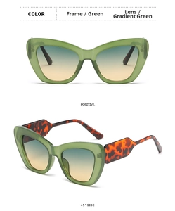 Close-up of cat-eye sunglasses featuring green transparent frames and tortoiseshell temples