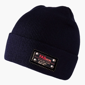Detail of navy knit beanie with fashion leather patch and silver metal rivets