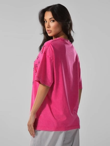 Detail view of pink washed cotton T-shirt with drop shoulders and side typography